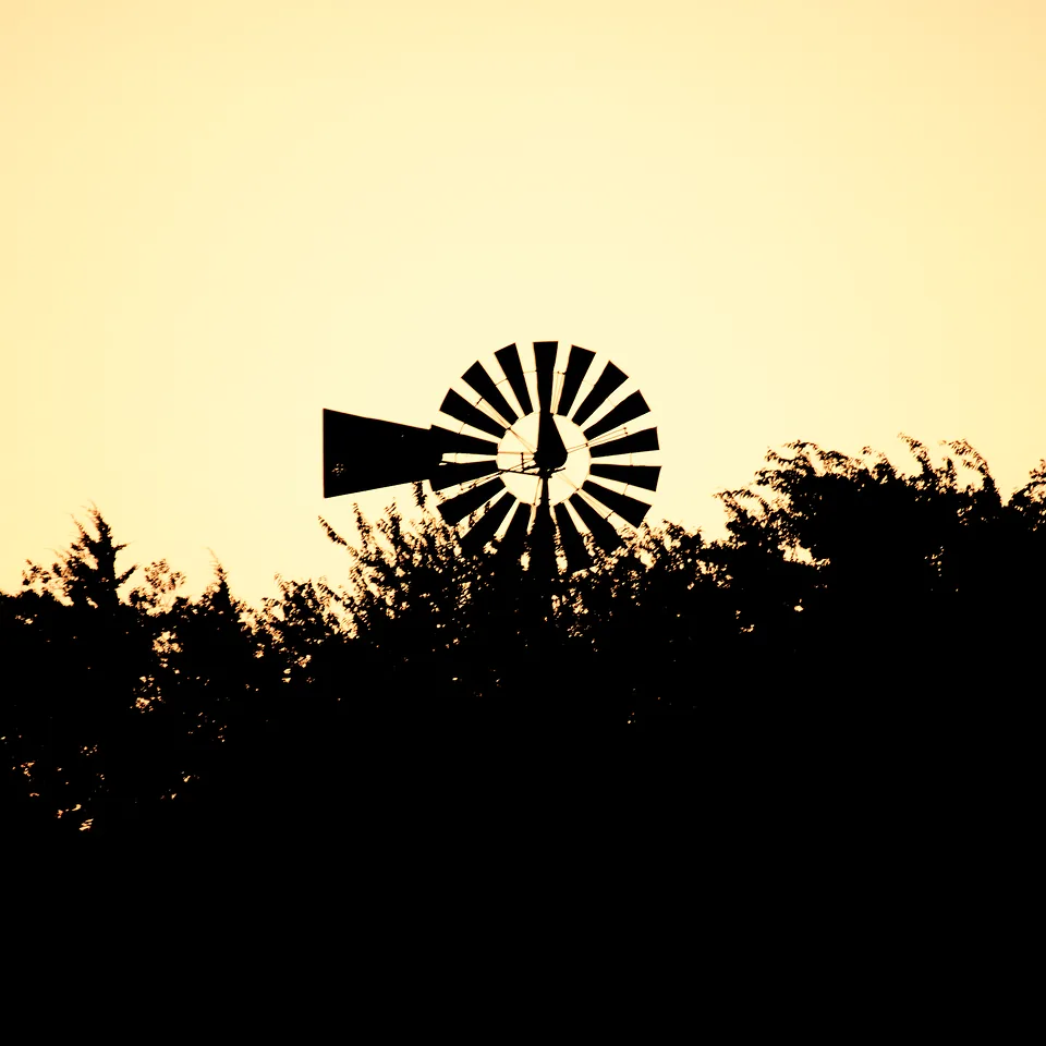 Windmill silhouette at golden hour