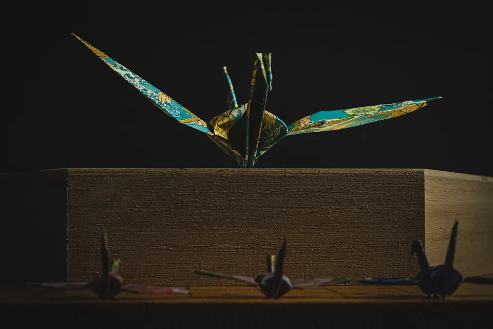 Origami cranes on a wooden box