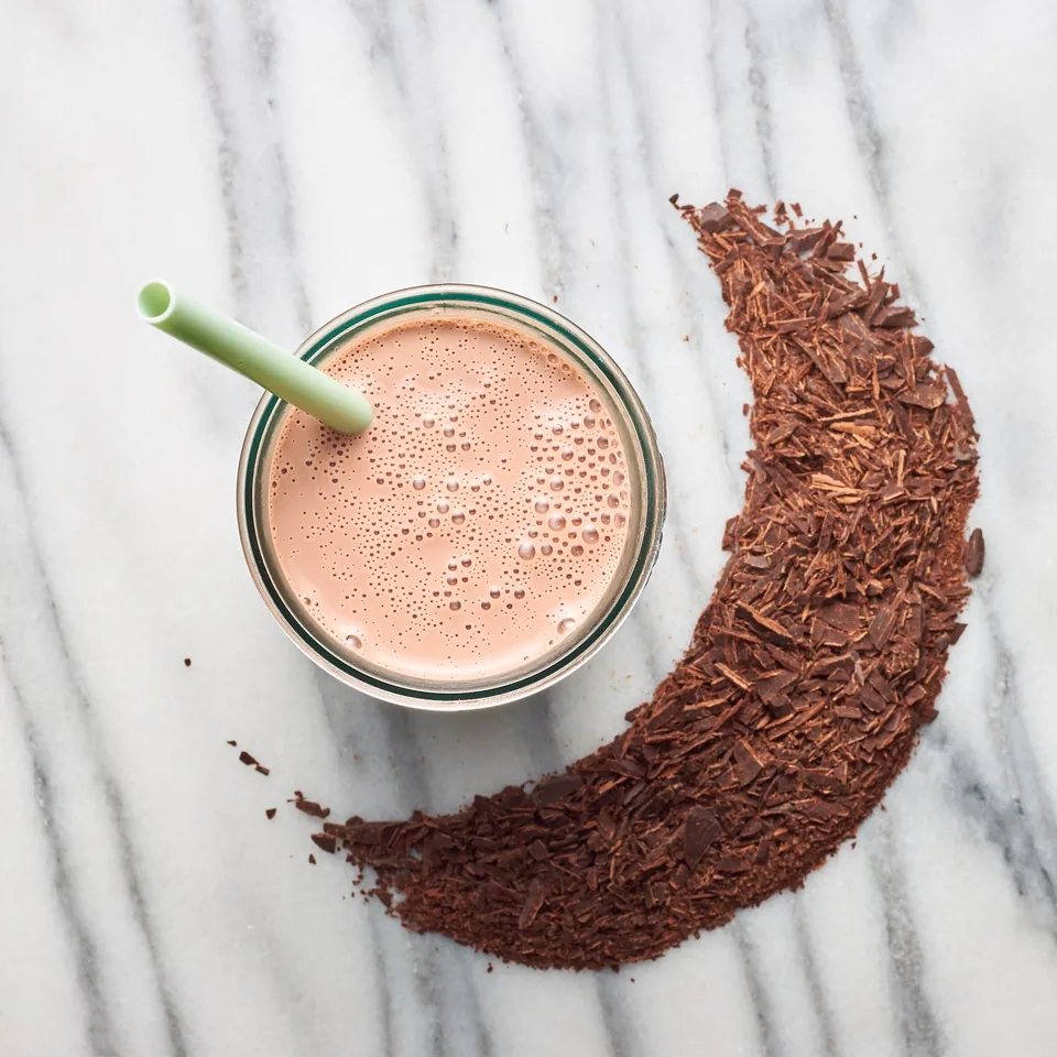 Chocolate milk with a cocoa crescent, on marble