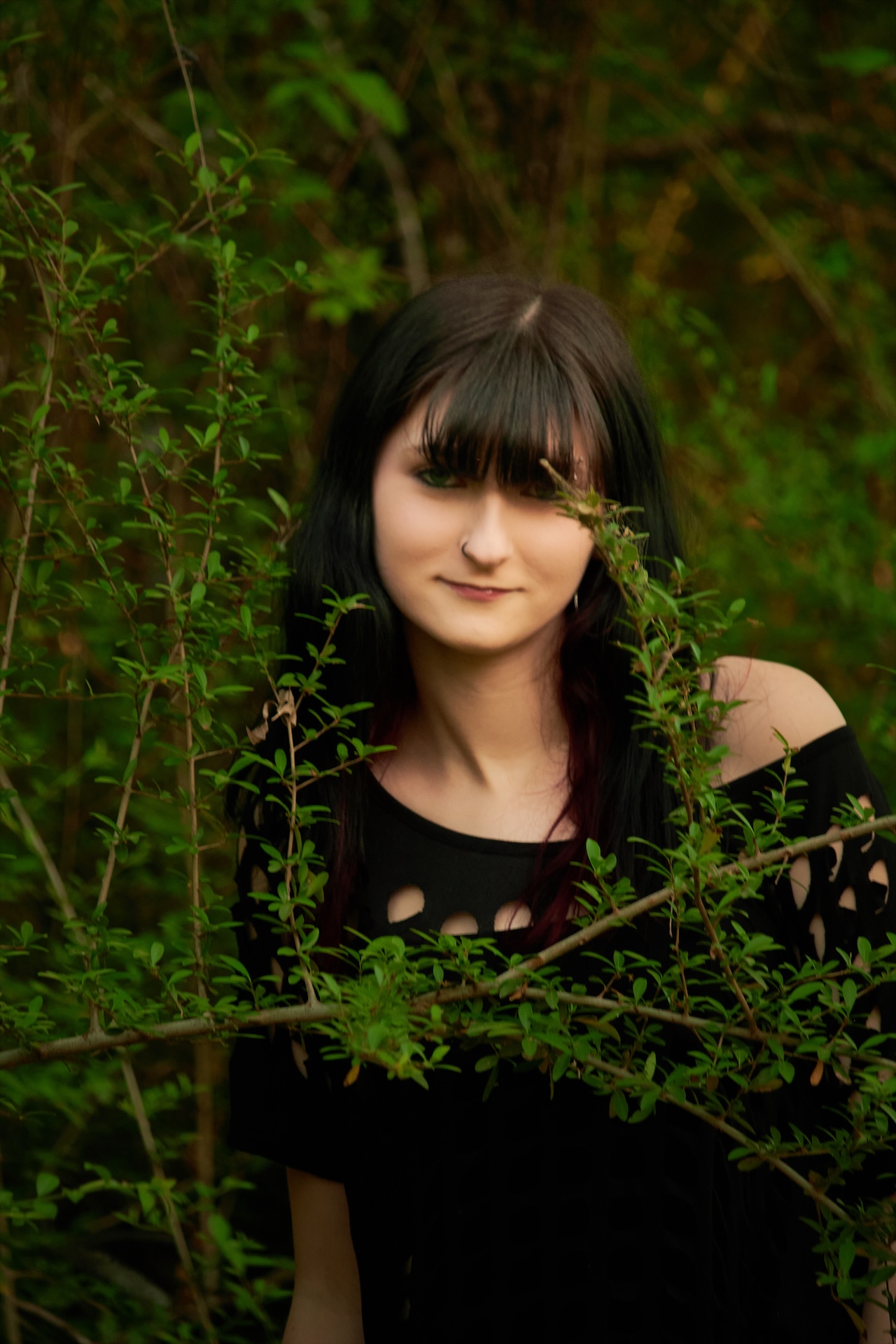 Environmental portrait through natural foliage