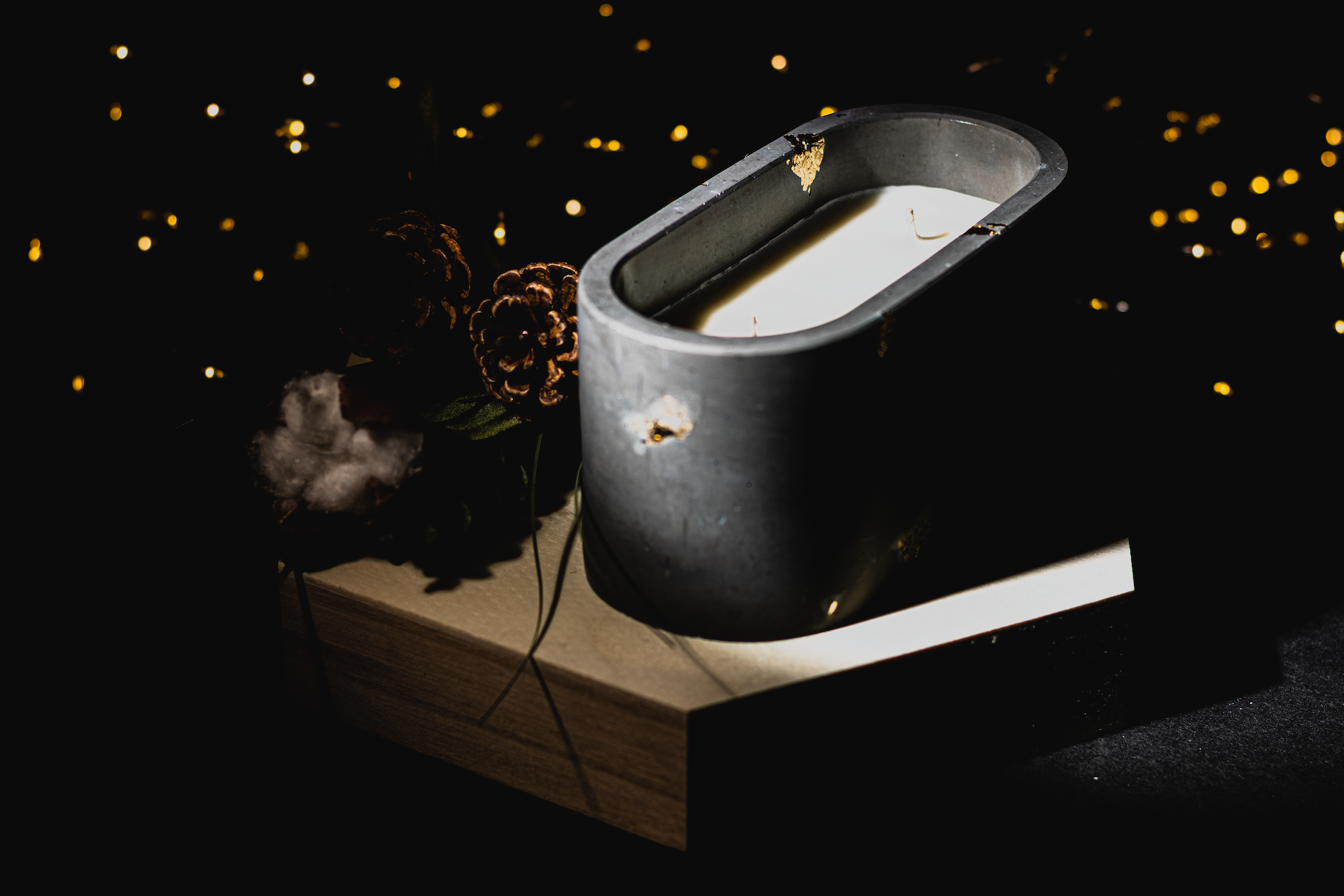 Concrete candle with bokeh fairy lights