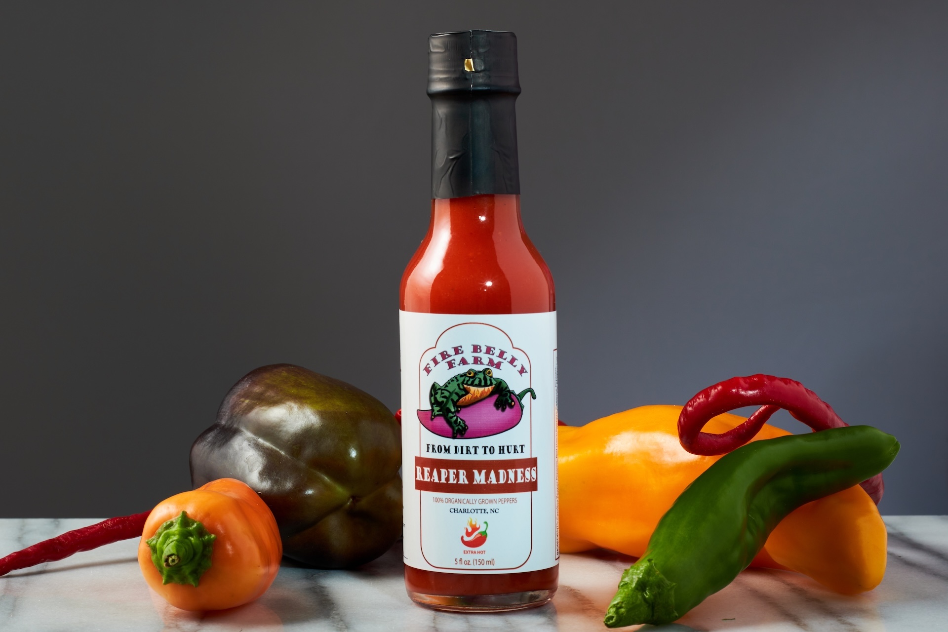 Fire Belly Farm hot sauce hero shot with peppers