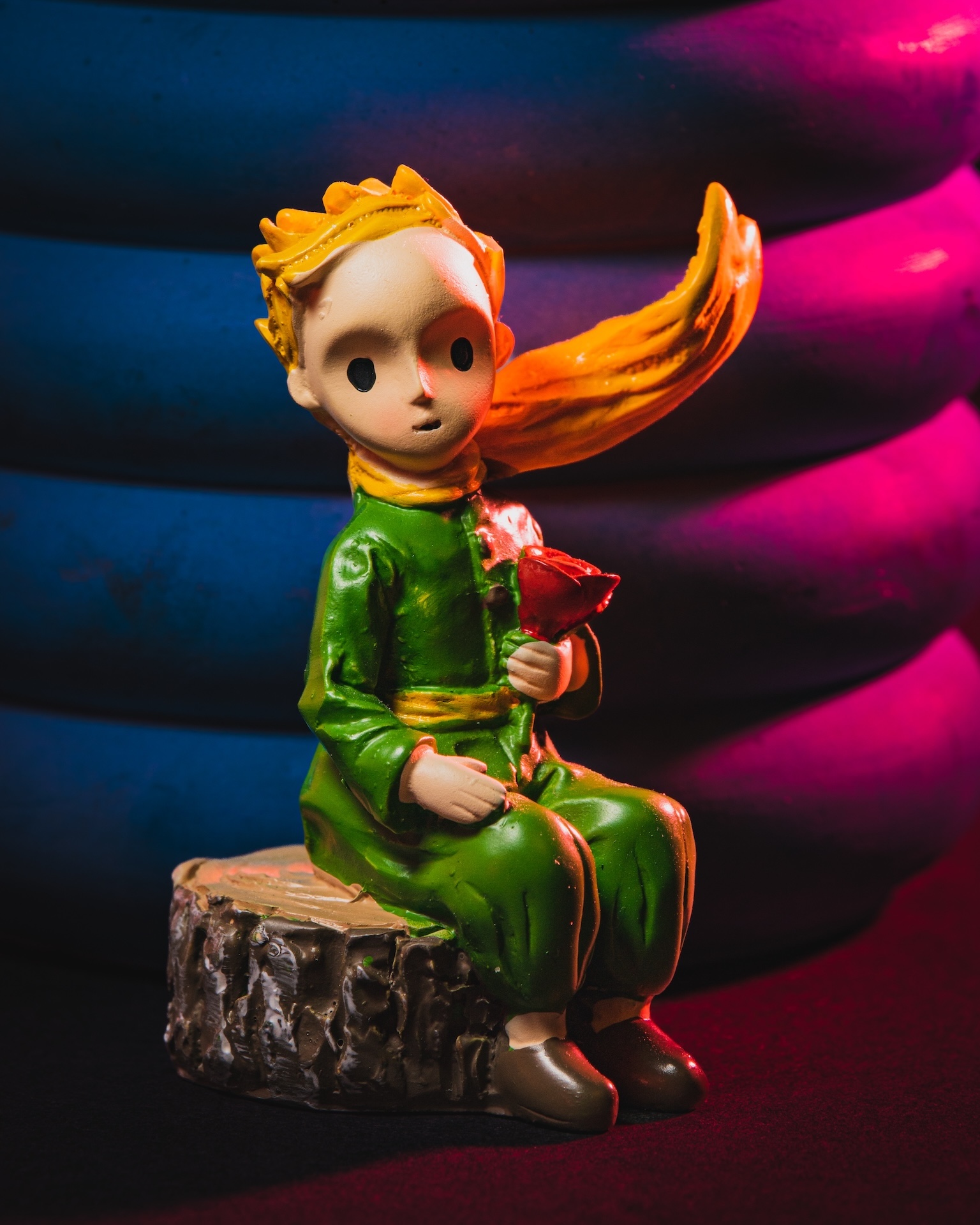 The Little Prince figurine, colorful dramatic lighting