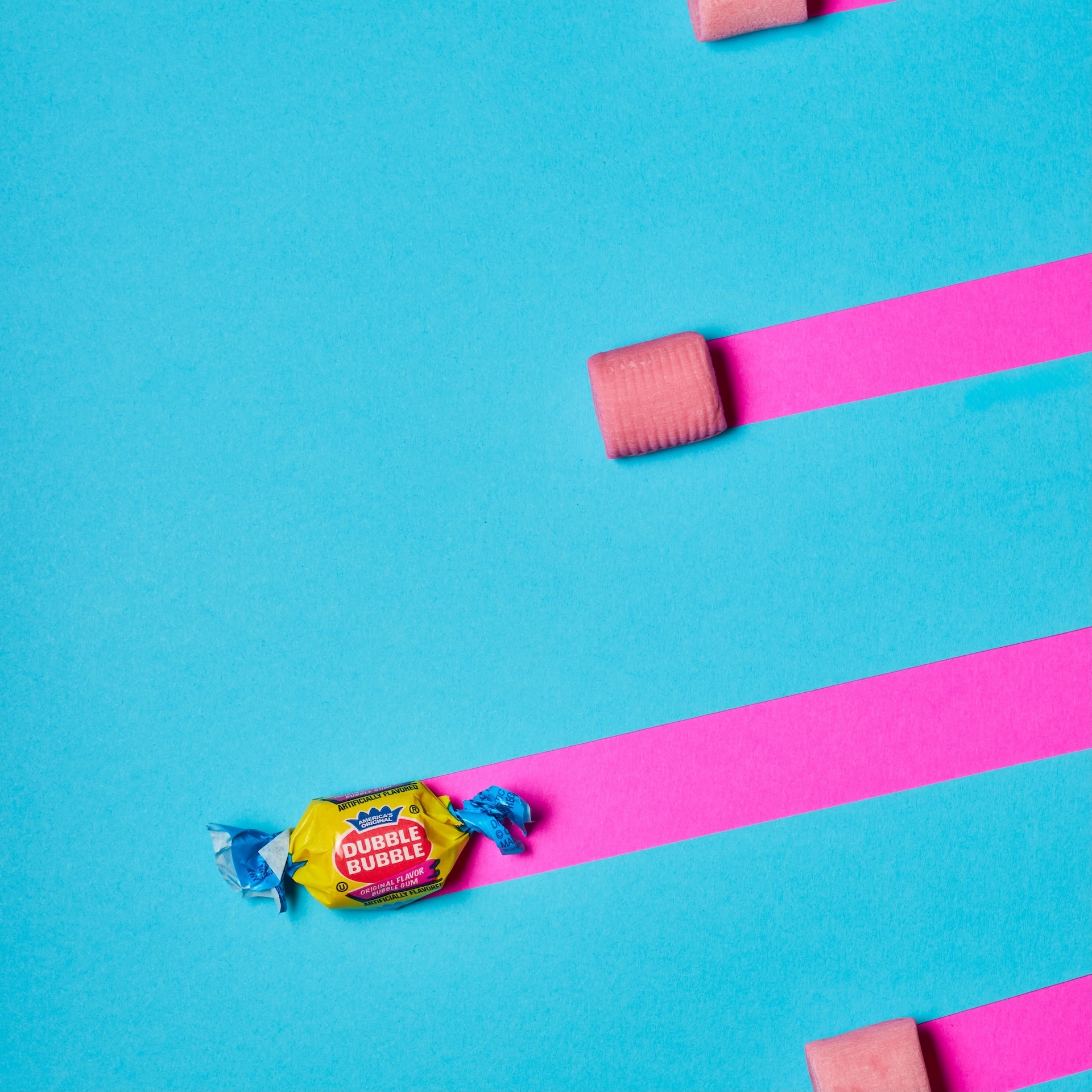 Dubble Bubble gum on teal and pink stripes