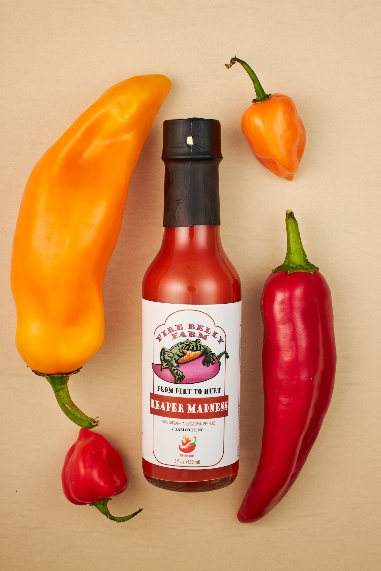 Hot sauce flat lay with fresh peppers